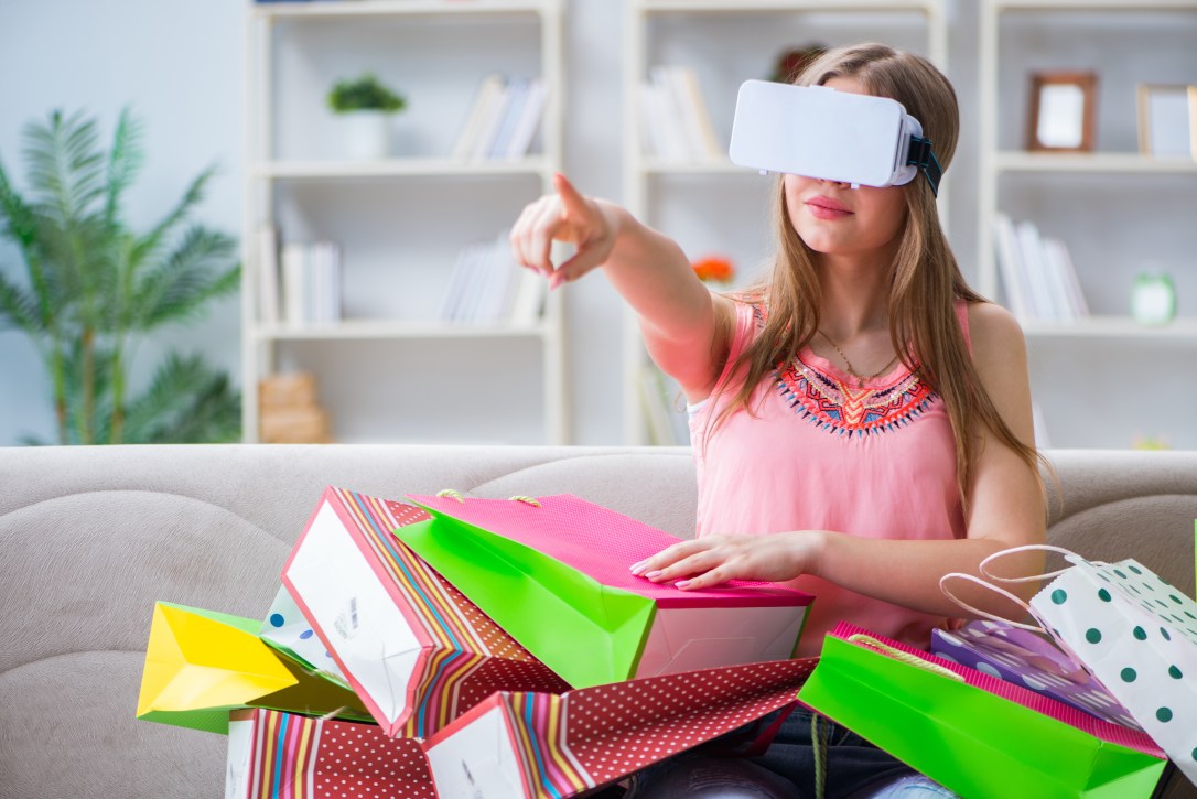 Young woman doing shopping with virtual reality glasses