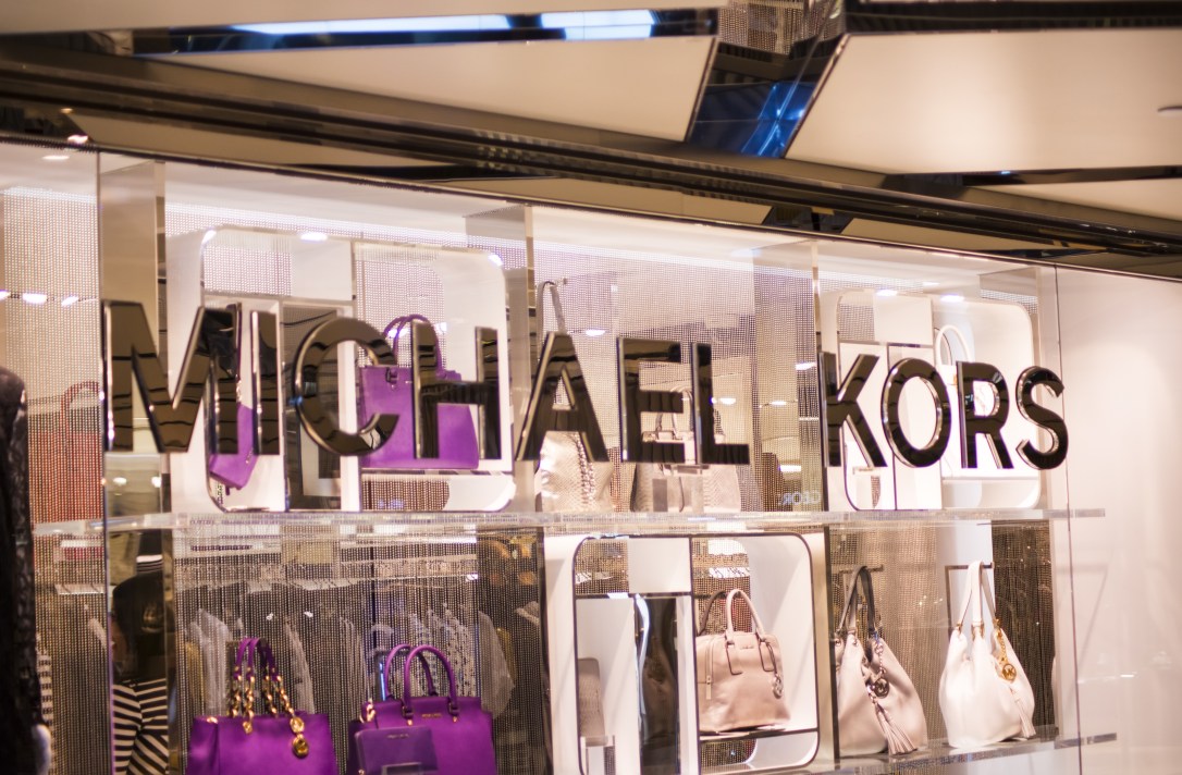 View at Michael Kors shop. Michael Kors is a New York City-based fashion designer widely known for designing classic American sportswear for women.