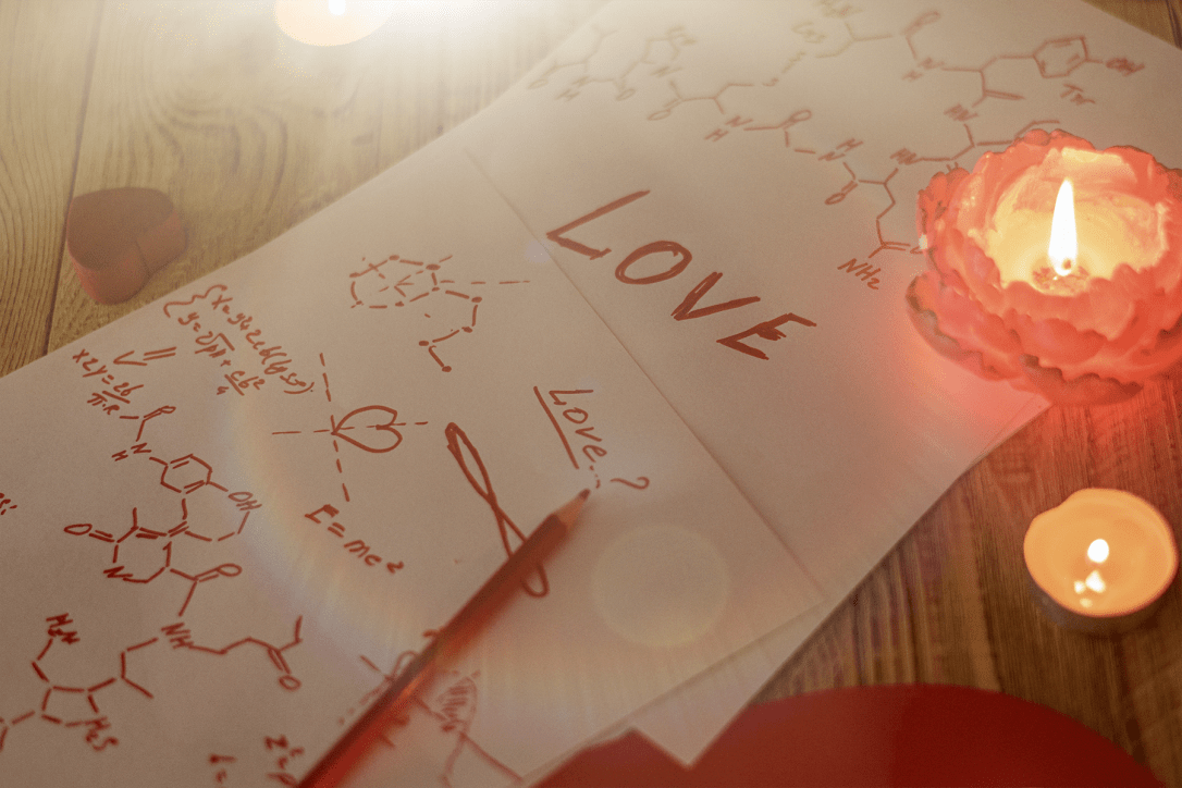 Formula love concept. Research, search for an answer to the question what is love. Sheets of paper with chemical formulas of hormones by candlelight